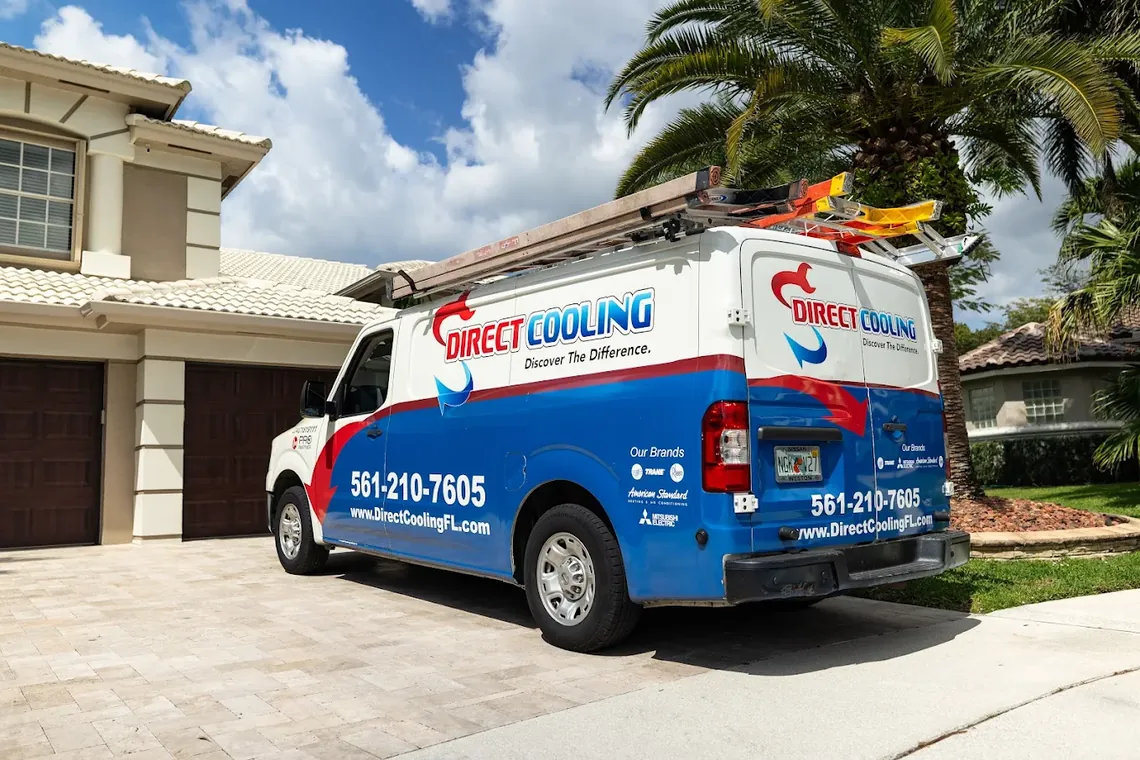 Direct Cooling service van with ladder rack parked in a residential driveway