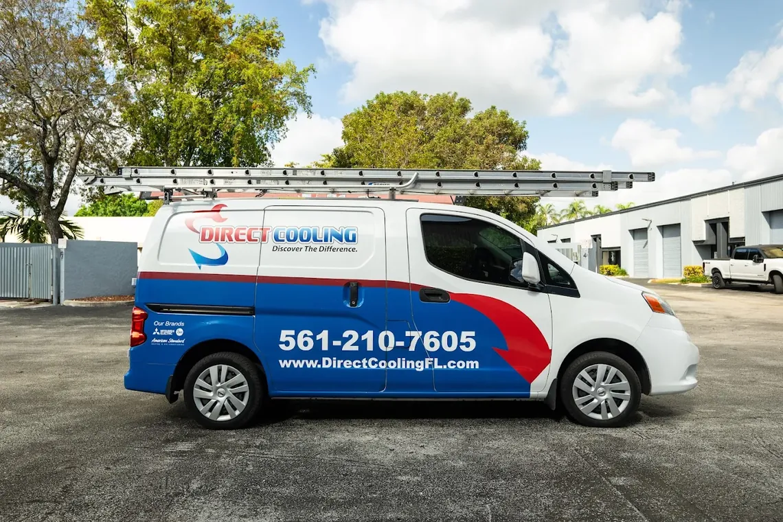 A Direct Cooling service van in the company red, white and blue livery with the dispatch number on the side. Direct Cooling service van with ladder rack parked in a lot