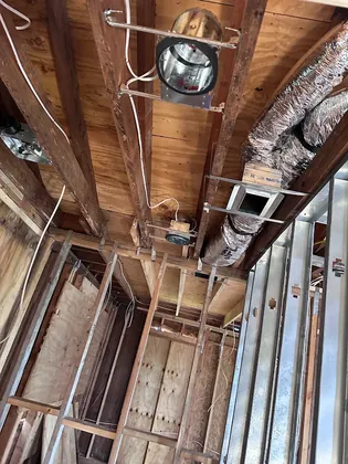 New insulated supply duct and register box in an open ceiling during a remodel